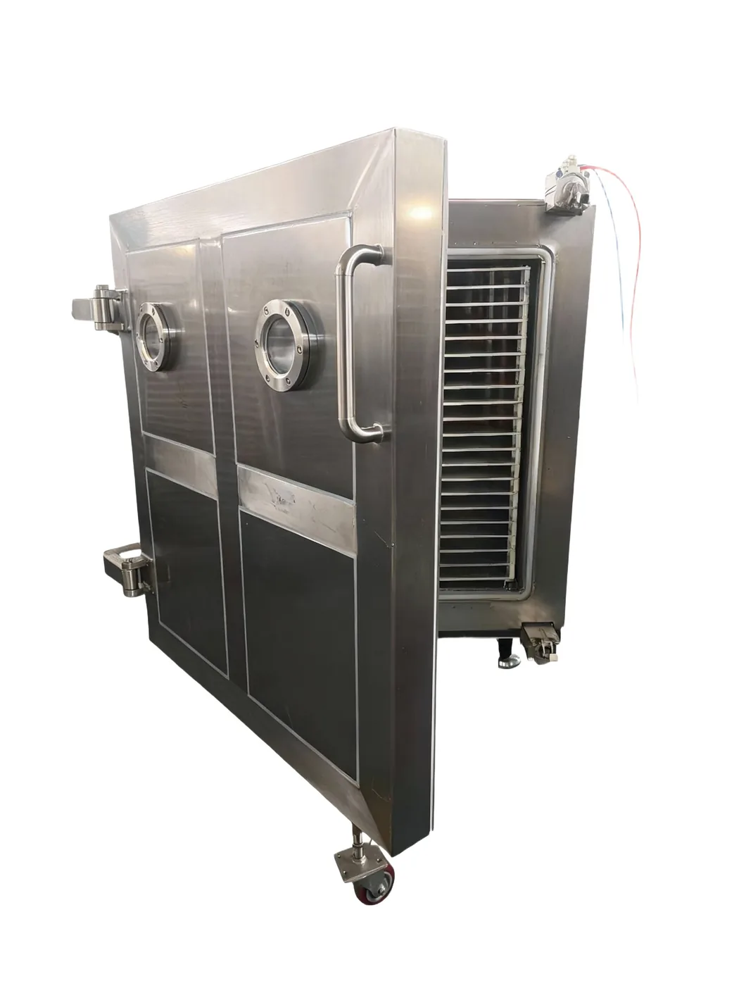 Freeze dryer chamber door open, showing the stacked product trays inside the stainless-steel chamber