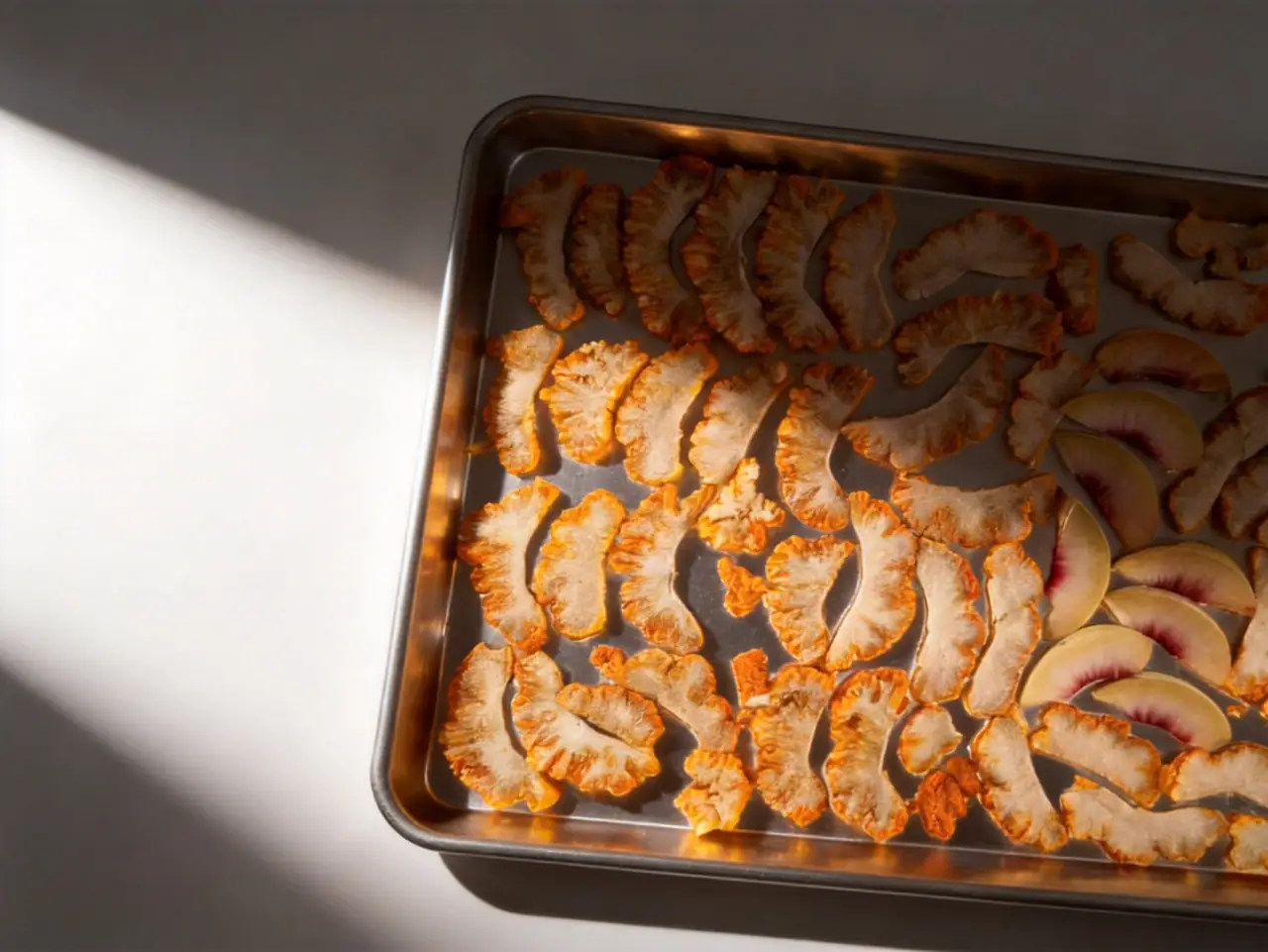 Freeze-dried mixed fruit slices on a tray: whole pieces with original shape and color preserved
